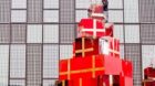 epa03018696 A worker sets up Christmas decorations outside a mall in Beijing, China, 29 November 2011. Christmas has been ado