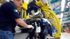 In this photo taken May 25, 2006, a worker adjusts a radiator in Italy's giant automaker Fiat's Mirafiori assembly plant, in