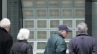Pedestrians are looking at SMI stock-market prices shown on screens at an UBS bank at the Bahnhofstrasse in Zurich, Switzerla