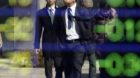Pedestrians are reflected on an electric stock board of a securities firm in Tokyo, Monday, Feb. 27, 2012. Japan's Nikkei 22