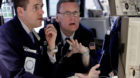In this Feb. 28, 2012 photo, a pair of specialists work at heir post on the floor of the New York Stock Exchange. Markets wer