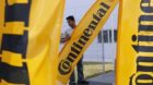 epa03319201 A worker puts up banners outside the new Continental AG Research and Development center in Singapore, 27 July 201