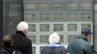 Pedestrians are looking at SMI stock-market prices shown on screens at an UBS bank at the Bahnhofstrasse in Zurich, Switzerla