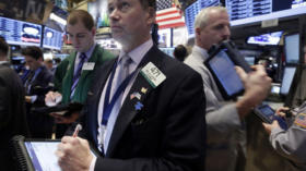 Neil Catania, center, works with fellow traders on the floor of the New York Stock Exchange Friday, Feb. 8, 2013. Stocks are