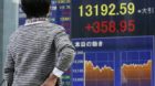 epa03653605 A pedestrian looks at a display board showing the Tokyo stock indexes in Tokyo, Japan, 08 April 2013. Japanese st