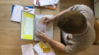 EDITOR'S NOTE: THE PHOTO WAS DIGITALLY EDITED TO HIDE PERSONAL INFORMATION. A man pays his bills via Postfinance's online por