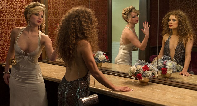 Rosalyn Rosenfeld (Jennifer Lawrence) & Sydney Prosser (Amy Adams) in the Grand Old AC Hotel powder room in Columbia Pictures' AMERICAN HUSTLE.