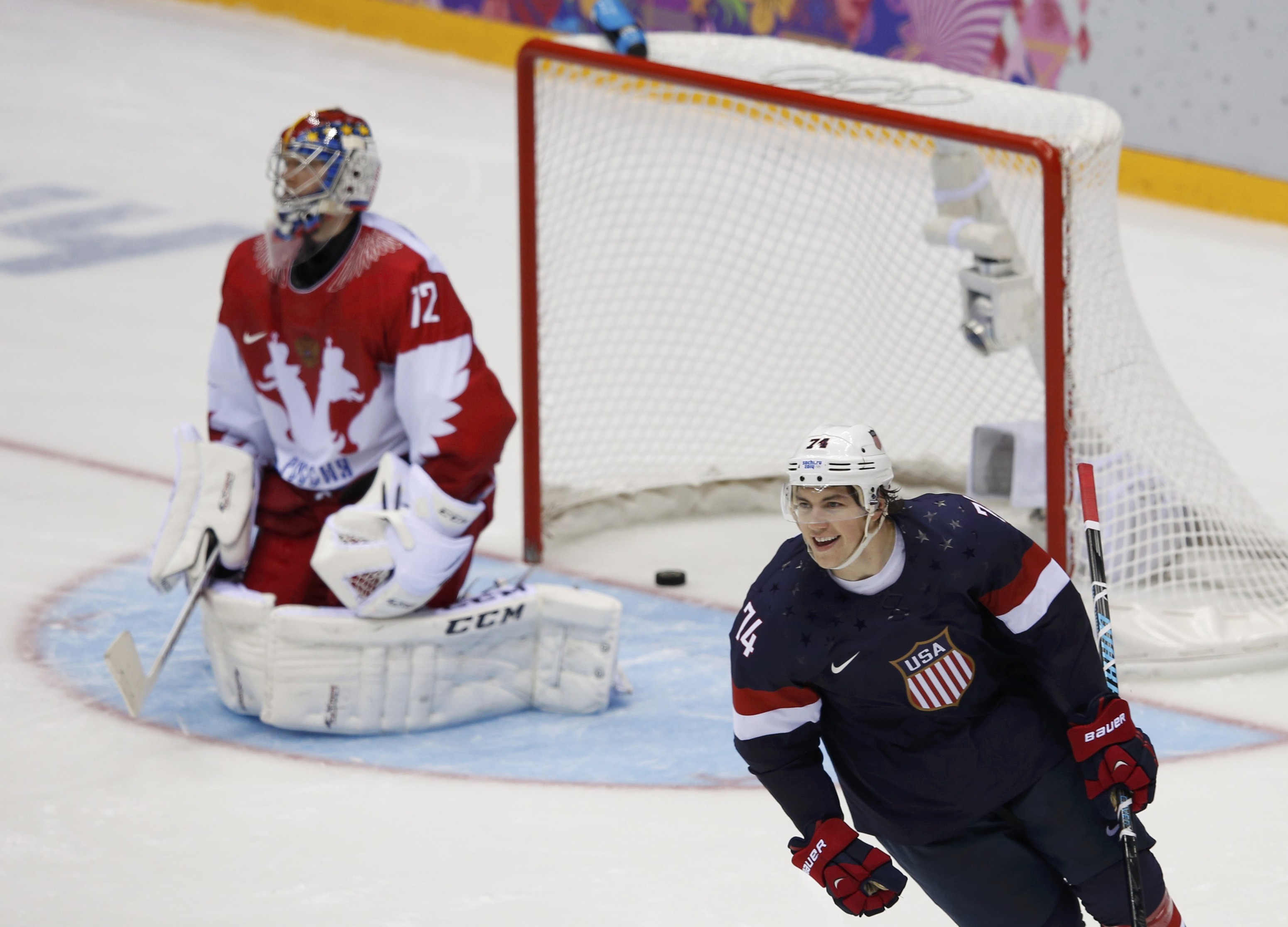 Team USA's T.J. Oshie (R) reacts after scoring the game-winning shootout goal against Russia's goalie Sergei Bobrovski during their men's preliminary round ice hockey game at the 2014 Sochi Winter Olympics, February 15, 2014.  REUTERS/Grigory Dukor (RUSSI
