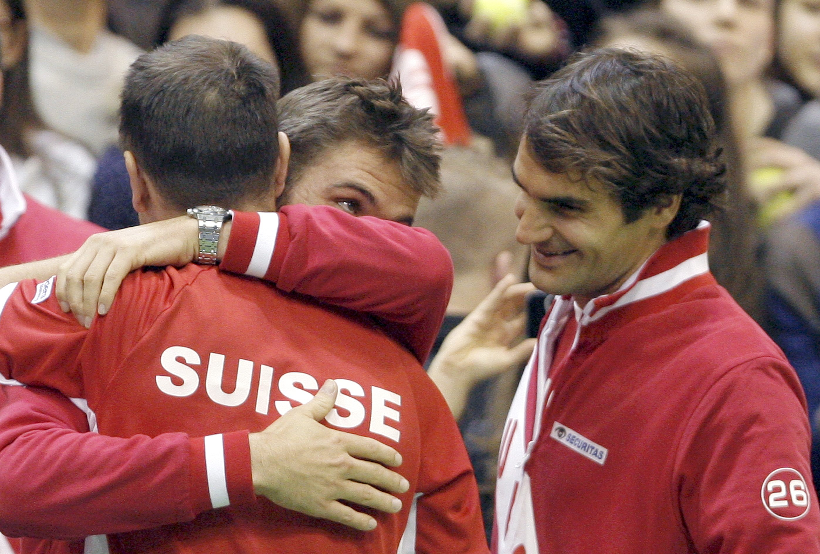 Switzerland's team captain Severin Luthi, Stanislas Wawrinka and Roger Federer (L-R) celebrate after winning their Davis Cup world group first round against Serbia in Novi Sad February 1, 2014. REUTERS/Novak Djurovic (SERBIA - Tags: SPORT TENNIS)