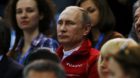 Russian President Vladimir Putin watches from the stands during the Team Ladies Free Skating Program at the Sochi 2014 Winter