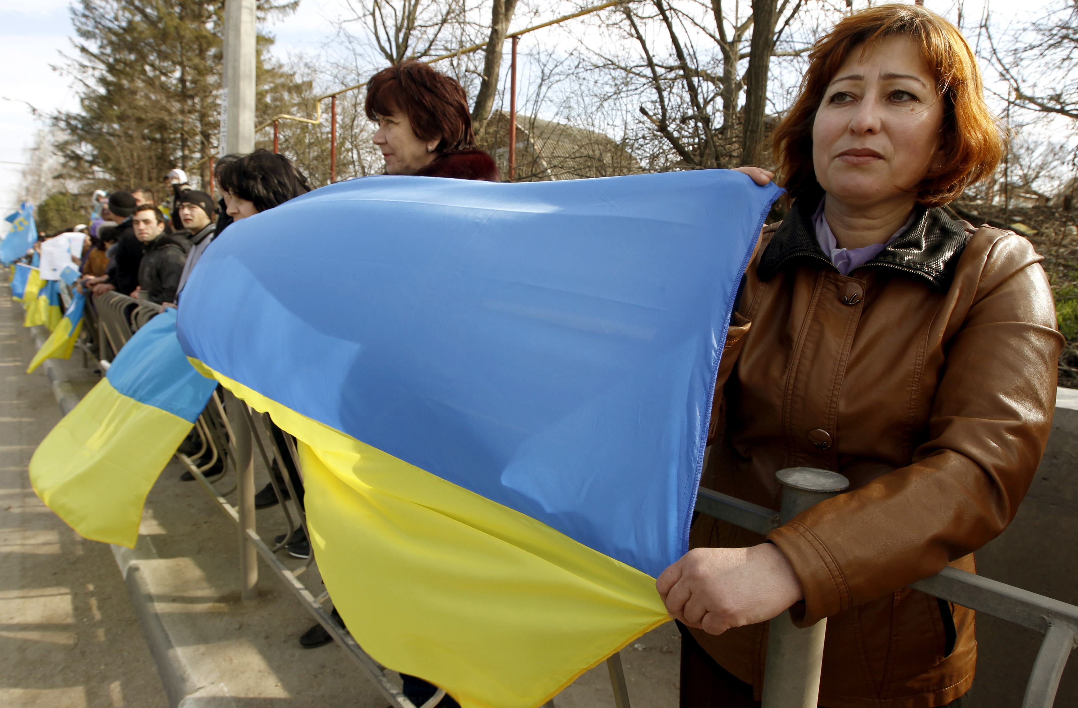 Crimean Tatars take part in a pro-Ukranian meeting in the Crimean village of Eskisaray, outside Simferopol, March 14, 2014. Russia shipped more troops and armour into Crimea on Friday and repeated its threat to invade other parts of Ukraine, showing no si