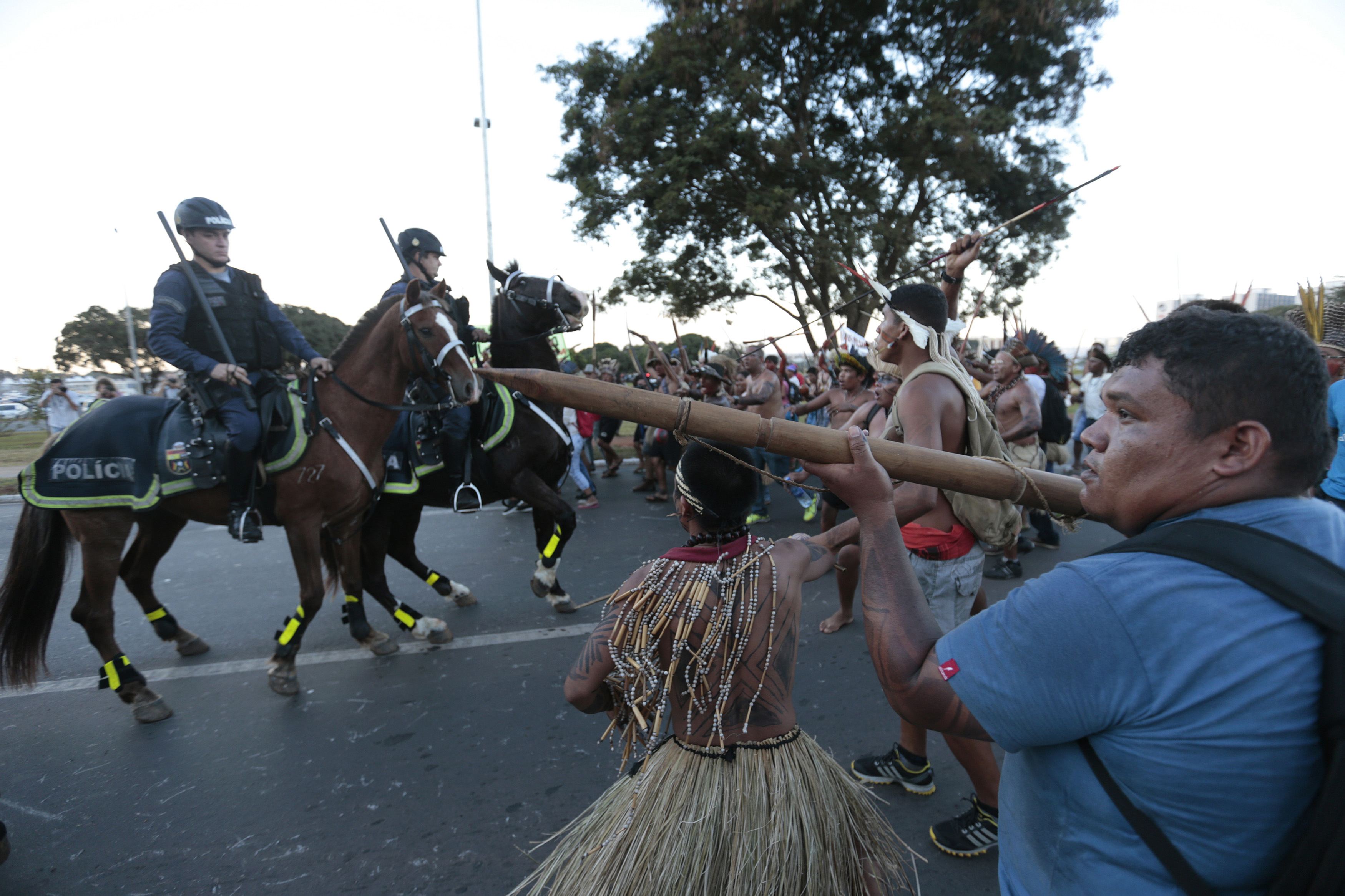Police confront native Brazilians to prevent them from marching towards the Mane Garrincha soccer stadium during a demonstration in Brasilia May 27, 2014. Indigenous people from different tribes protested against the government's Indian policy and the cos