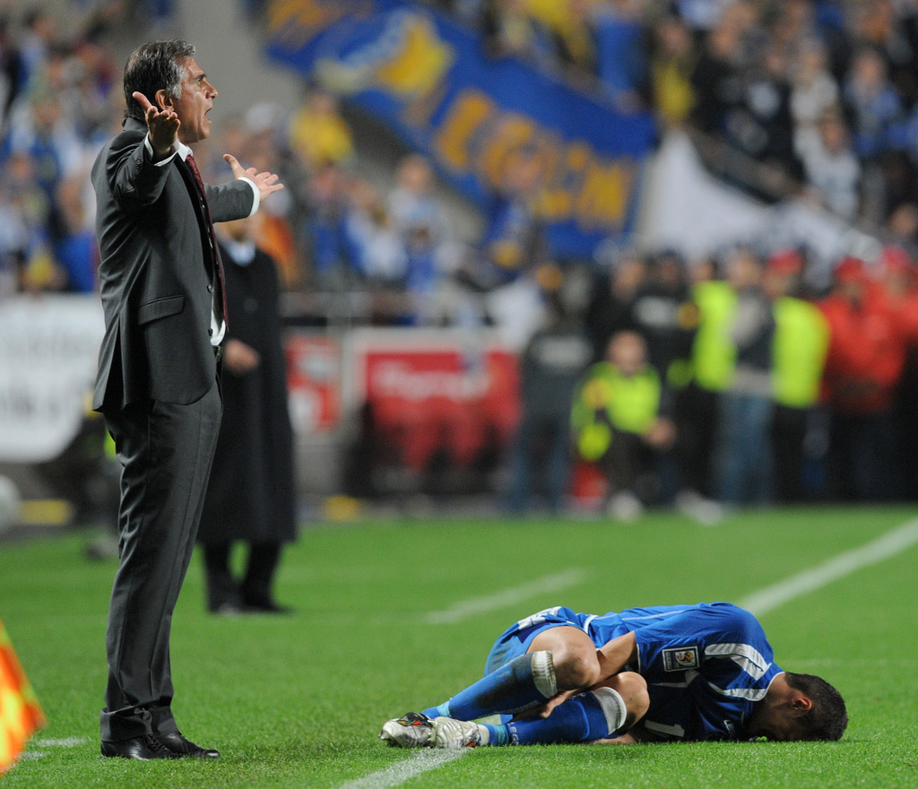 Portugal's coach Carlos Queiroz, left, reacts as Bosnia-Herzegovina's Sejad Salihovic grimaces in pain on the pitch during their World Cup qualifying playoff first leg soccer match Saturday, Nov. 14, 2009, at the Luz stadium in Lisbon, Portugal. Portugal 
