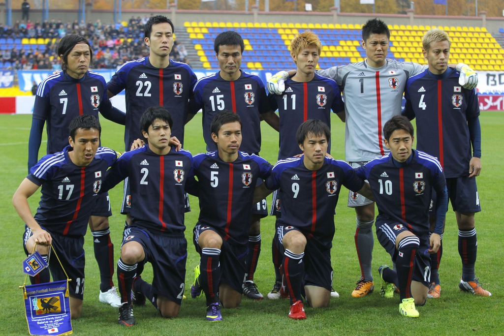 FILE - In this Oct. 15, 2013 file photo, Japan soccer team poses prior to the start their friendly soccer match against Belarus in Zhodino, Belarus. Background from left: Yasuhito Endo, Maya Yoshida,Yasuyuki Konno, Yoichiro Kakitani, Eiji Kawashima and Ke