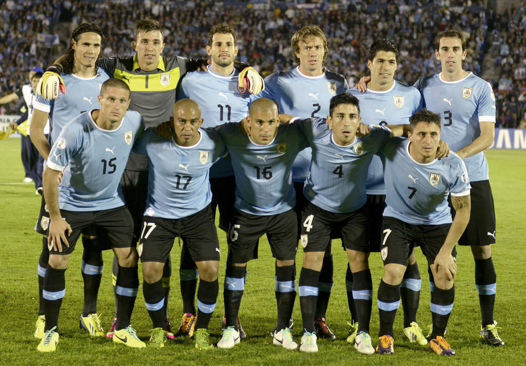 FILE - In this Oct. 15, 2013 file photo, Uruguay soccer team poses prior to the start the 2014 World Cup qualifying soccer match between Uruguay and Argentina in Montevideo, Uruguay. Foreground from left: Diego Perez, Egidio Arevalo, Maximiliano Pereira,