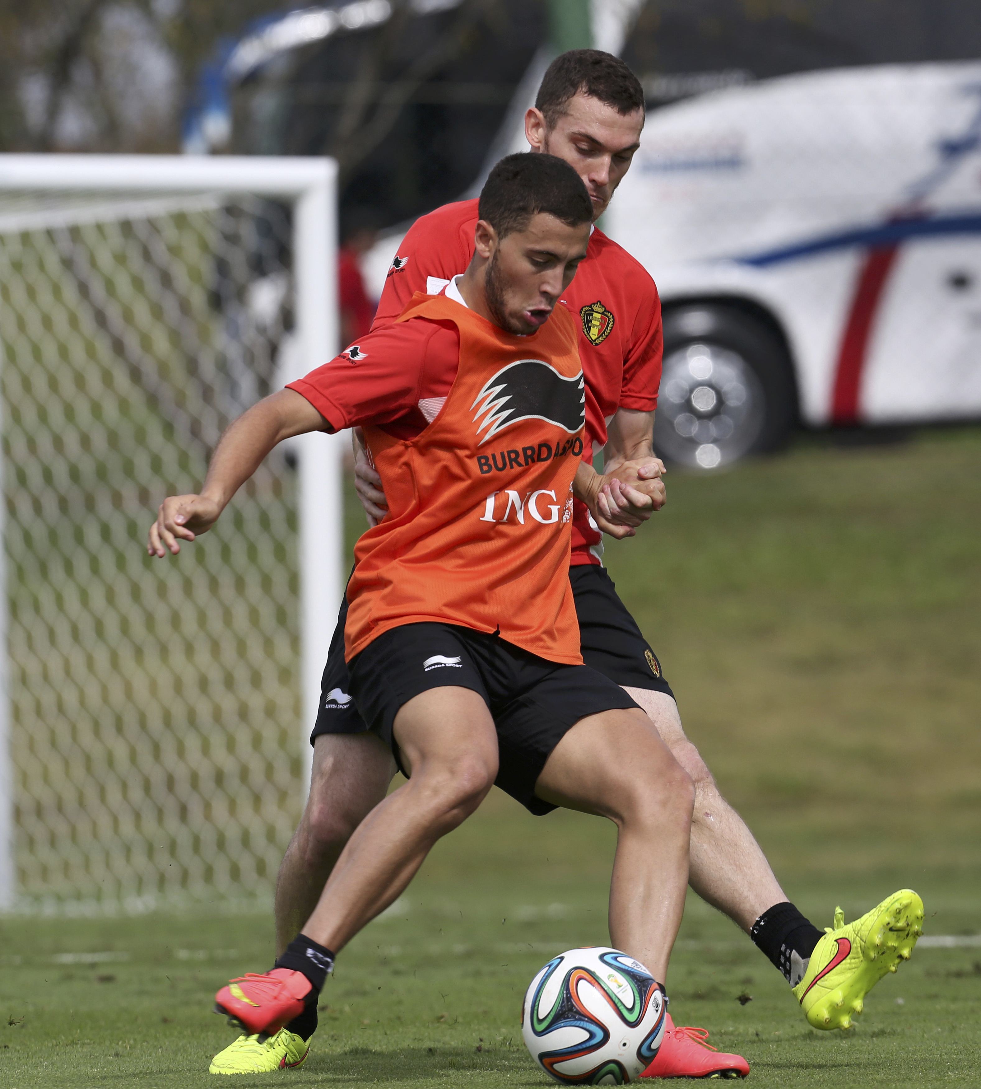 Belgium's national soccer team players Eden Hazard (Front) and Thomas Vermaelen fight for the ball during a training session in Mogi das Cruzes, near Sao Paulo June 14, 2014. Belgium will play its first match of the 2014 World Cup against Algeria on June 
