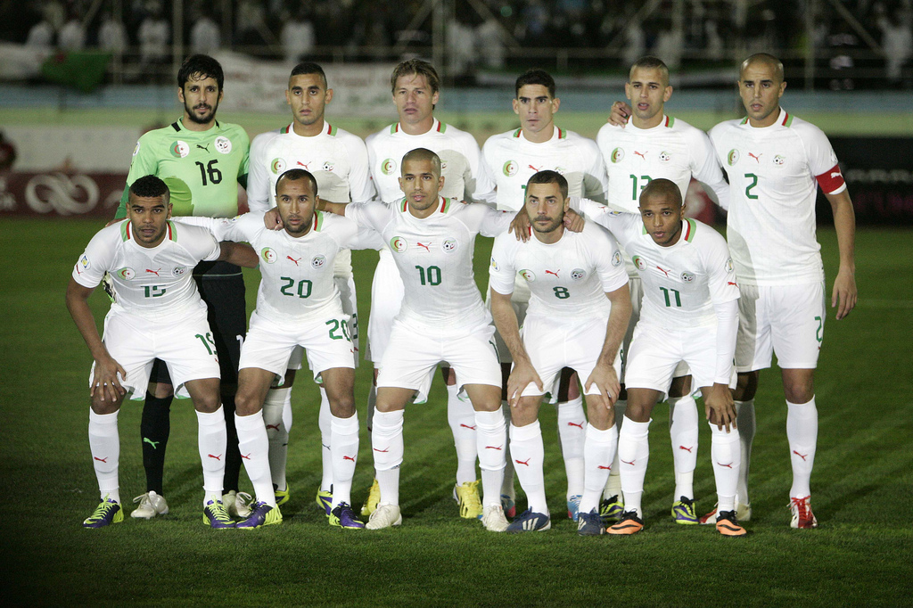 In this Nov. 19, 2013 photo, Algeria's national soccer team poses prior to the start the World Cup qualifying soccer match between Burkina Faso and Algeria in Blida, Algeria. Background from left: Mohamed Lamine Zemmamouche, Faouzi Ghoulam, Mehdi Mostefa-