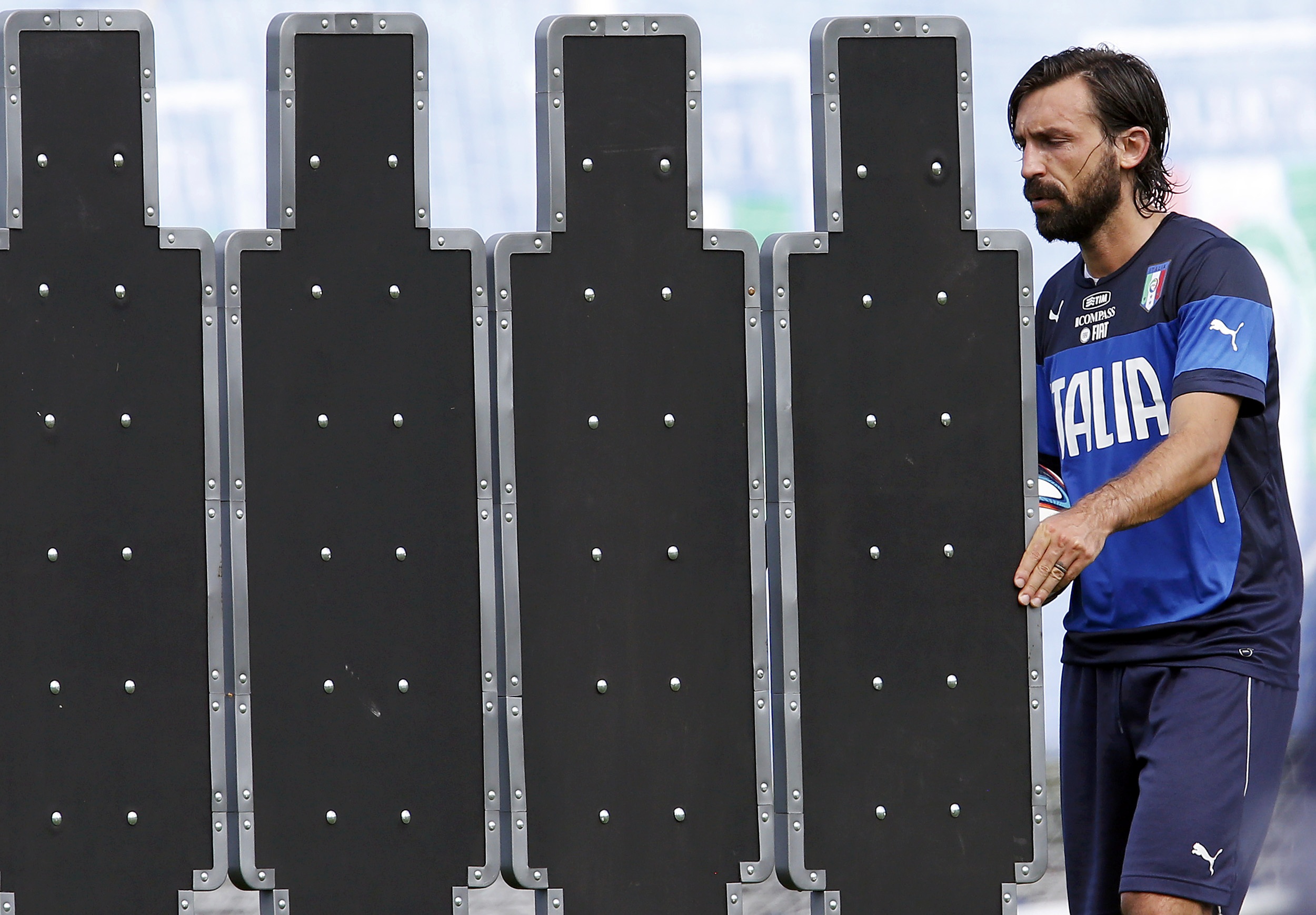 Italy's national soccer player Andrea Pirlo moves the barrier for the free kicks during a training session ahead of the 2014 World Cup at the Portobello training center in Mangaratiba June 11, 2014.  REUTERS/Alessandro Garofalo (BRAZIL  - Tags: SPORT SOCC