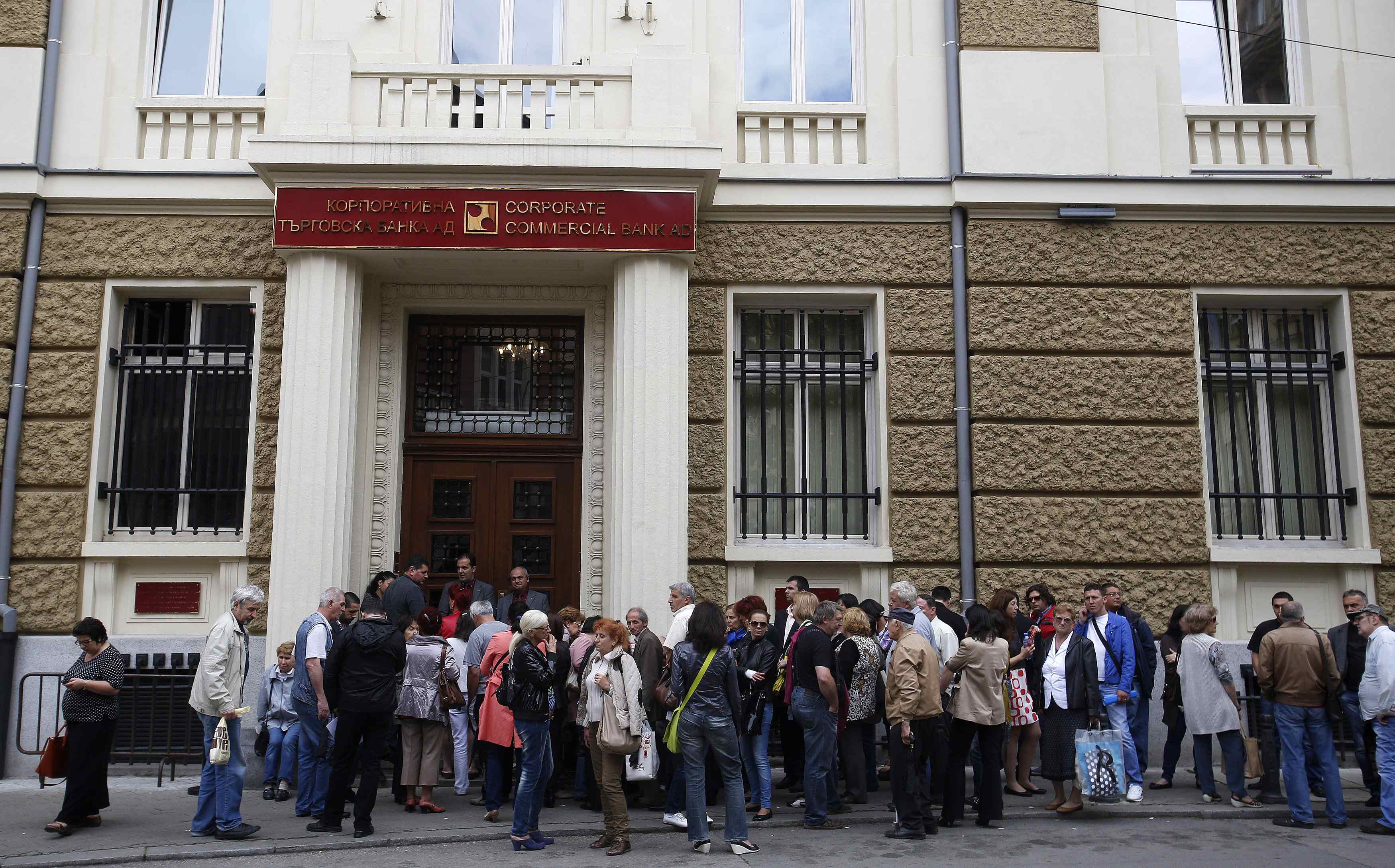 People queue outside the main office of Bulgaria's Corporate Commercial Bank in Sofia June 20, 2014. Adverse media reports triggered a bank run on Bulgaria's Corporate Commercial Bank (Corpbank) this week, the central bank governor said on Friday, appeali