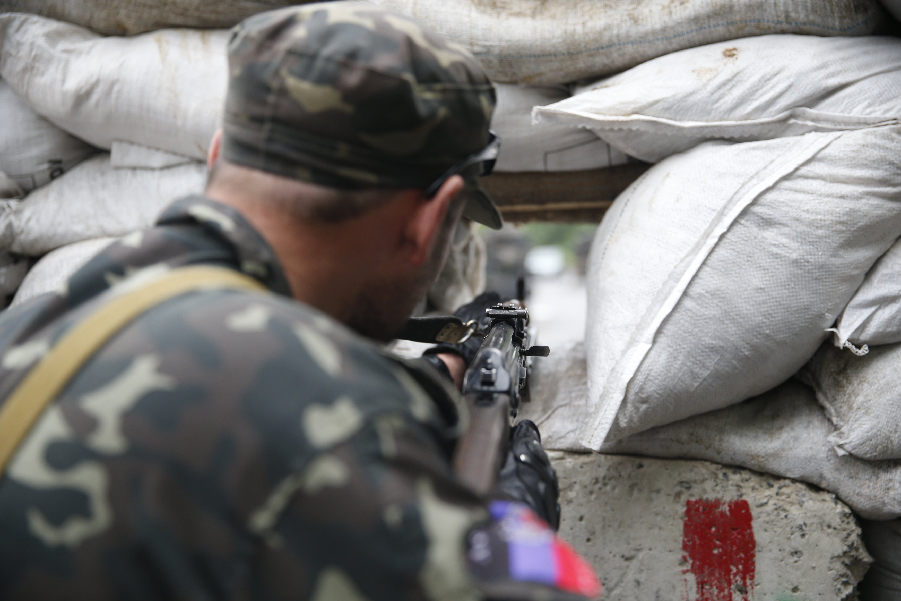 A pro-Russian fighter mans a checkpoint in the eastern Ukrainian city of Donetsk July 7, 2014. Pro-Russian rebels erected new barricades on the streets of Donetsk on Monday, preparing to make a stand in the city of a million people after losing their bast