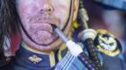 epa04320615 A picture made available on 18 July 2014 shows a member of the Massed Pipes and Drums performing during a rehears