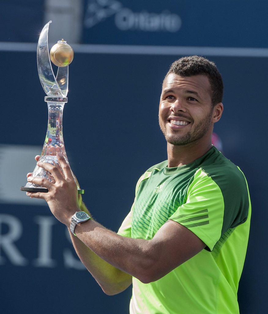 epa04348860 Jo-Wilfried Tsonga of France poses with the trophy after defeating Roger Federer of Switzerland in the final match of the Rogers Cup mens tennis tournament in Toronto, Canada, 10 August 2014. EPA/WARREN TODA