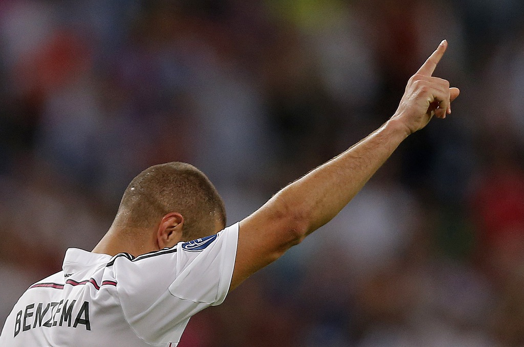 Real Madrid's Karim Benzema celebrates after scoring his side's fifth goal during the Champions League Group B soccer match between Real Madrid and Basel at the Santiago Bernabeu stadium in Madrid, Spain, Tuesday Sept. 16, 2014. (AP Photo/Daniel Ochoa de