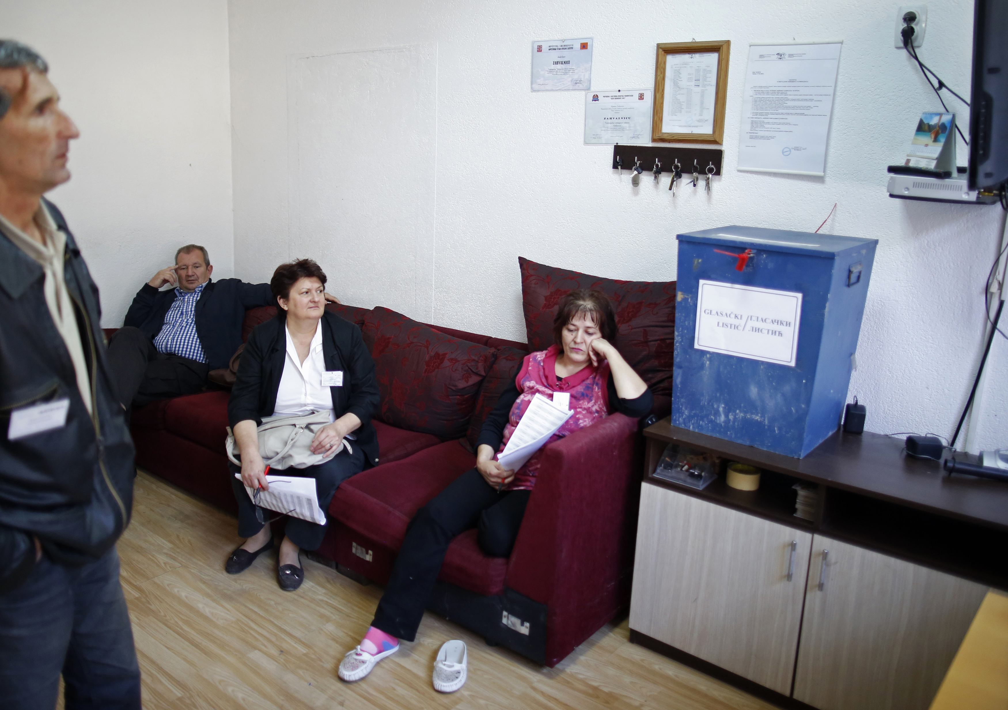 Members of the Election Commission wait for voters at a polling booth in Potocari, near Srebrenica October 12, 2014. Bosnians vote for national, regional and local representatives on Sunday in elections dominated by still-unresolved issues of identity and