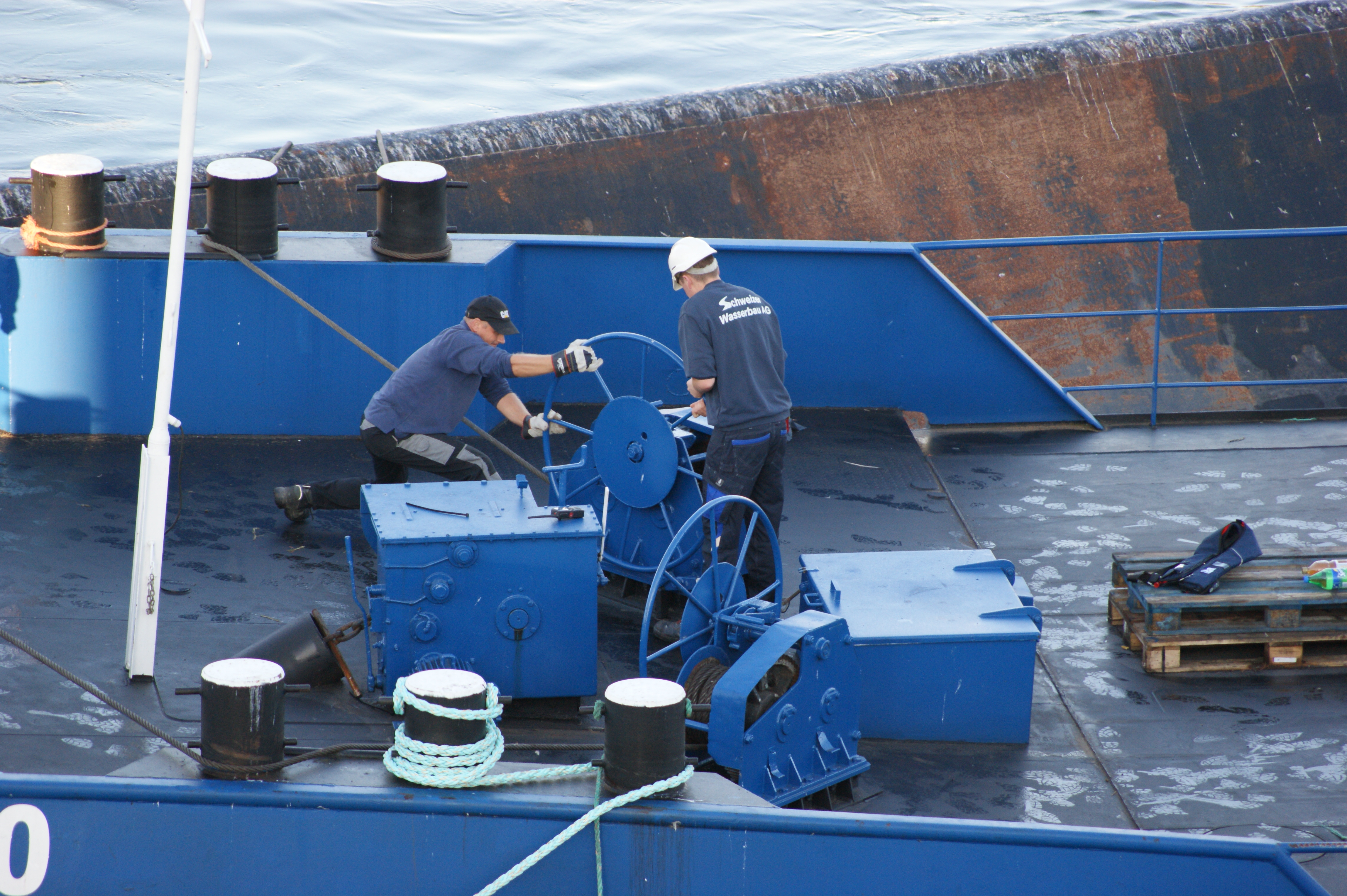 Harte Arbeit für wenige Zentimeter: Die Arbeiter auf dem zusätzlich gelieferten Ponton sichern die Merlin.