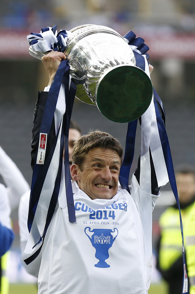 FCZ's head coach Urs Meier celebrates with the trophy after the Swiss Cup final soccer match between FC Basel and FC Zurich at the Stade de Suisse stadium in Bern, Switzerland, Monday, April 21, 2014. (KEYSTONE/Peter Klaunzer)