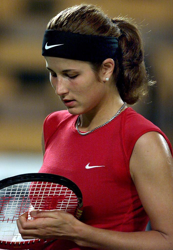 PER14 - 20020101 - PERTH, AUSTRALIA : A dejected Miroslava Vavrinec of Switzerland looks at her racket strings during her match against Arantxa Sanchez-Vicarion of Spain, in the Hopman Cup mixed teams' tennis event at the Burswood Dome in Perth, 01 January 2002. Sanchez-Vicarion won in straight sets 6-2, 6-0. EPA PHOTO AFPI/GREG WOOD