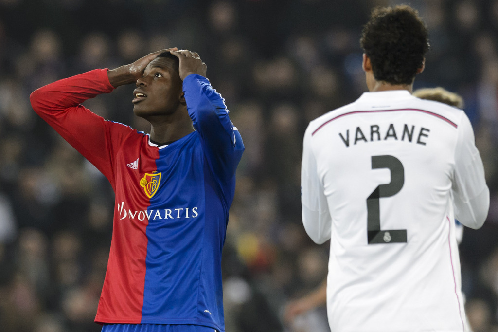 Basel's Breel Embolo, left, freacts next to Madrid�s Raphael Varane, right, during an UEFA Champions League group B matchday 5 soccer match between Switzerland's FC Basel 1893 and Spain's Real Madrid CF in the St. Jakob-Park stadium in Basel, Switzerland, on Wednesday, November 26, 2014. (KEYSTONE/Laurent Gillieron)