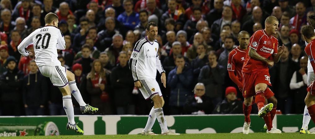 Basel's Fabian Frei, left, follows through after scoring the opening goal during the Champions League Group B soccer match between Liverpool and FC Basel at Anfield Stadium in Liverpool, England, Tuesday, Dec. 9, 2014. (AP Photo/Jon Super)