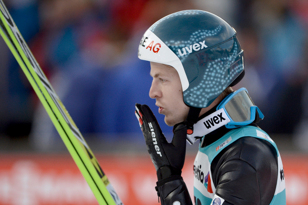 Michael Hayboeck from Austria celebrates his 3rd place after the men's FIS World Cup Ski Jumping at the Titlisschanze in Engelberg, Switzerland, Sunday, 21 December 2014. (KEYSTONE/Urs Flueeler)