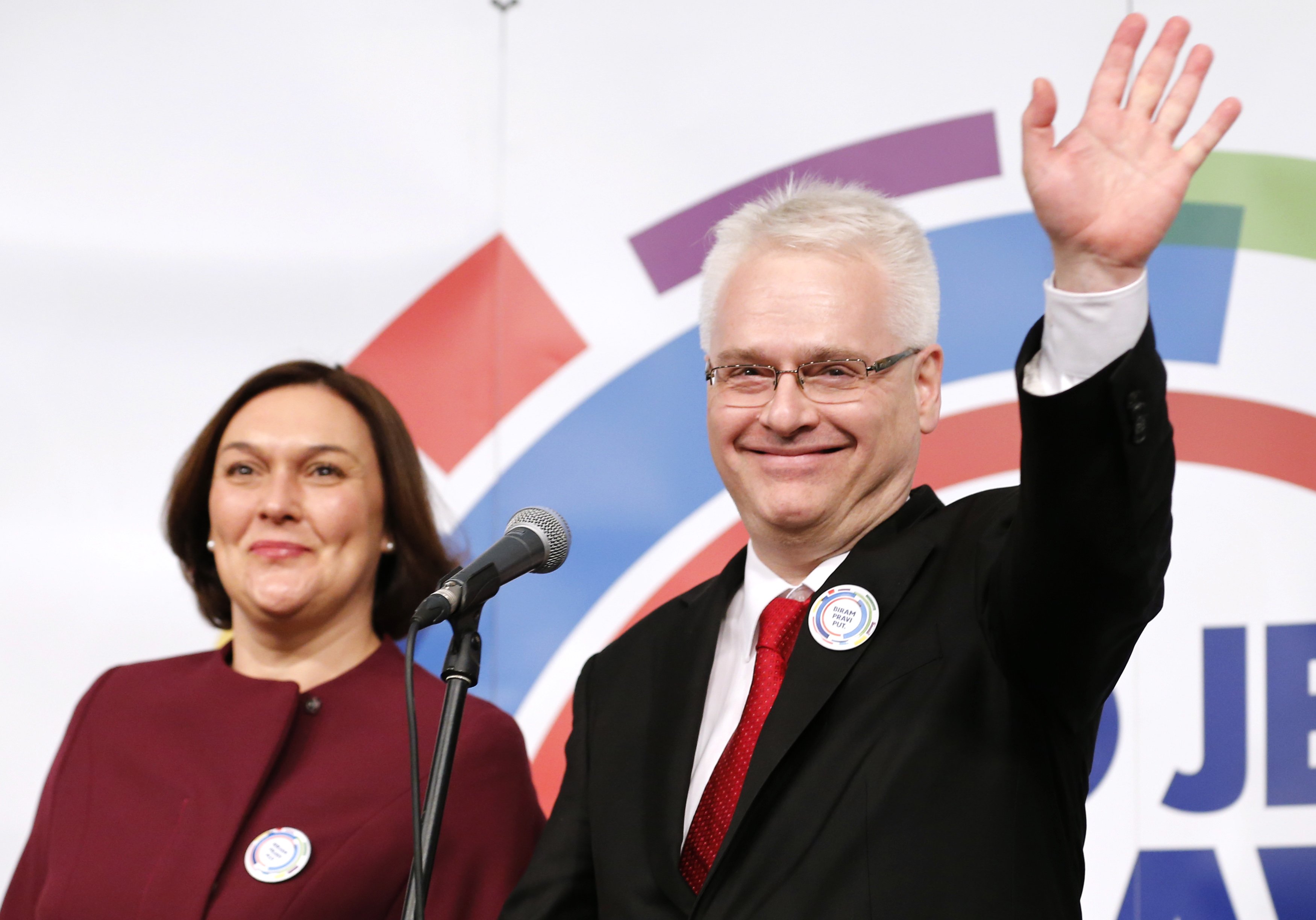 Croatian president and presidential candidate Ivo Josipovic stands with his wife Tatjana Josipovic as he waves to supporters after the unofficial results in the headquarters in Zagreb December 28, 2014. Josipovic faces a tight run-off next month to try to win a second five-year term as Croatia's president after failing to secure a majority from voters frustrated by the country's economic malaise. REUTERS/Antonio Bronic (CROATIA - Tags: POLITICS ELECTIONS)
