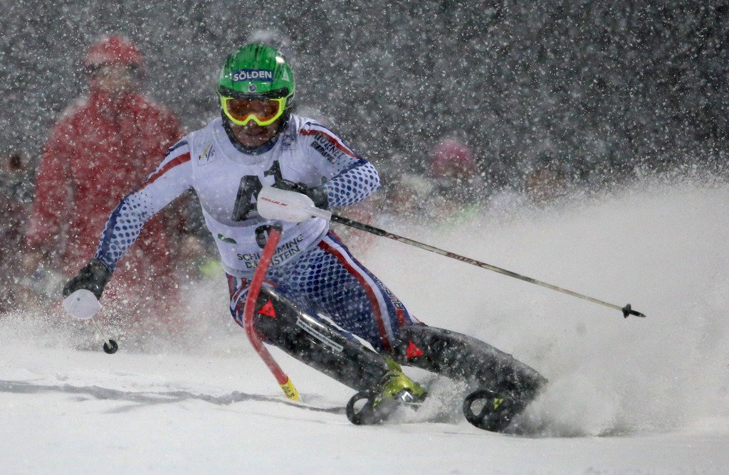 Alexander Khoroshilov, of Russia, speeds past a pole on his way to clock the fastest time during the first run of a men's World Cup slalom event, in Schladming, Austria, Tuesday, Jan. 27, 2015. (AP Photo/Giovanni Auletta)