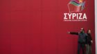 Workers talk after setting a banner for a pre-election campaign rally of opposition radical leftist Syriza party in Athens Ja