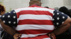 An overweight man wears a shirt patterned after the American flag during a visit to the World Trade Center, Thursday, May 8,