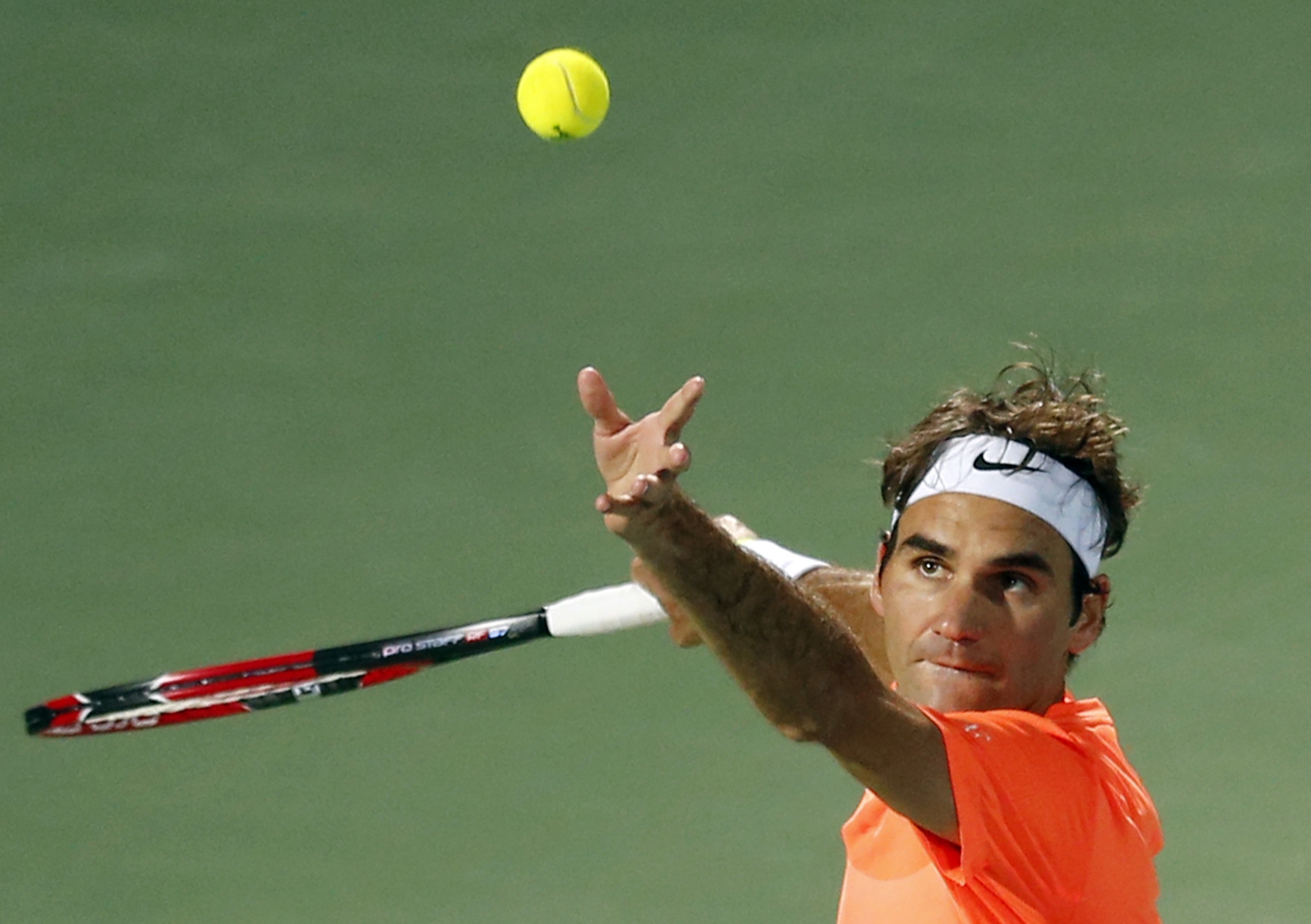 Roger Federer of Switzerland serves to Mikhail Youzhny of Russia during their match at the ATP Championships tennis tournament in Dubai, February 23, 2015. REUTERS/Ahmed Jadallah (UNITED ARAB EMIRATES - Tags: SPORT TENNIS)