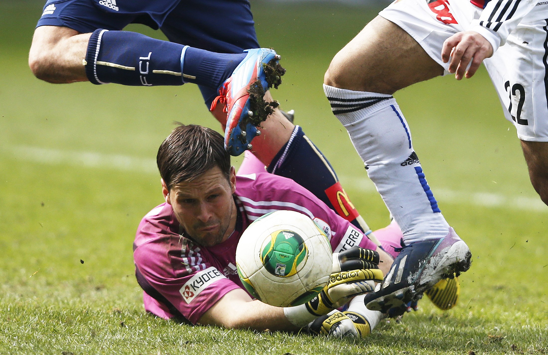 FC Luzern's goalkeeper David Zibung fails to save the ball as FC Basel's Mohamed Salah (R) scores the third goal of the match against FC Luzern during their Swiss Super League soccer match in Lucerne April 1, 2013. REUTERS/Michael Buholzer (SWITZERLAND - Tags: SPORT SOCCER)