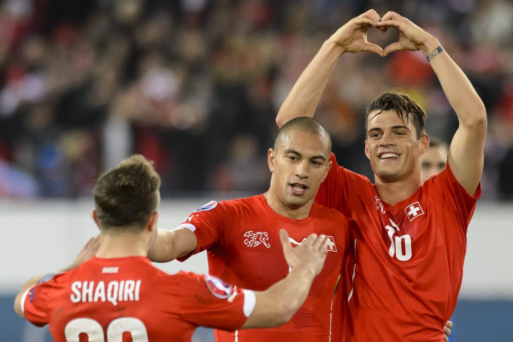 epa04682578 From left, Swiss forward Xherdan Shaqiri, Swiss midfielder Goekhan Inler and Swiss forward Granit Xhaka celebrate the second goal during the UEFA EURO 2016 group E qualifying football match Switzerland against Estonia at the Swissporarena in Lucerne, Switzerland, Friday, March 27, 2015. EPA/LAURENT GILLIERON