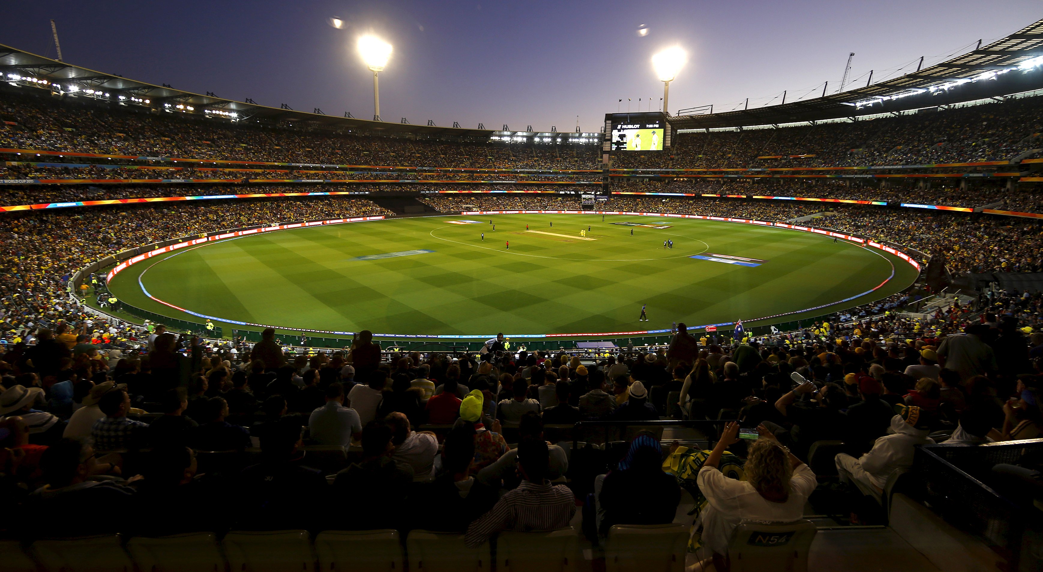 Members of the crowd watch as Australia and New Zealand play their Cricket World Cup final match at the Melbourne Cricket Ground (MCG) March 29, 2015. Picture taken through a window. REUTERS/David Gray