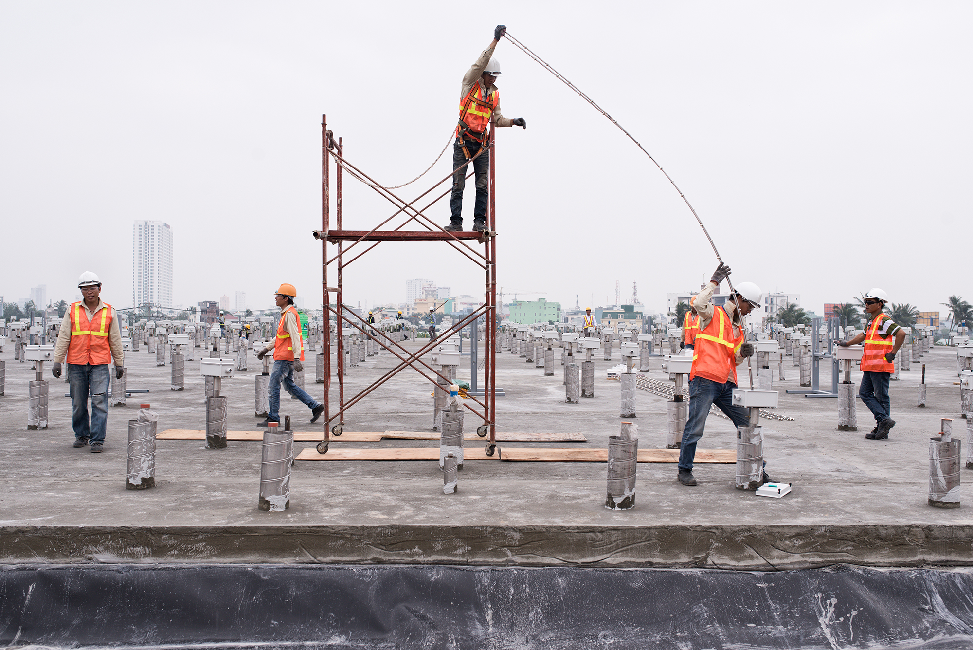 Da Nang. 09.12.2013 - Agent Orange cleanup at the airport. The U.S. Agency for International Development (USAID) has awarded contracts to two U.S. companies to work on the project along with Vietnam defense ministry officials. Oven in which the contanimated earth is heated. Workers fix heating rods on top of the oven. Photo by ©Roland Schmid