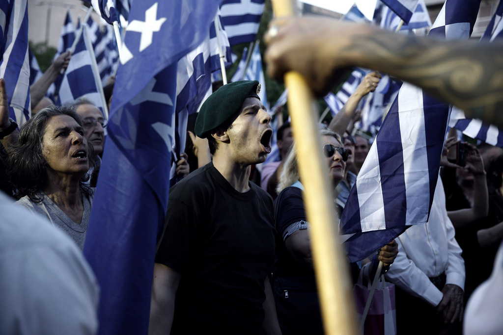 FILE - In this Friday, May 23, 2014 file photo, supporters shout slogans and wave Greek flags during the main election rally of the extreme right party Golden Dawn in Athens. The formerly fringe Nazi-rooted party, which won 0,29 percent in the pre-crisis 2009 elections, saw its popularity explode during the bailout years. (AP Photo/Petros Giannakouris, File)