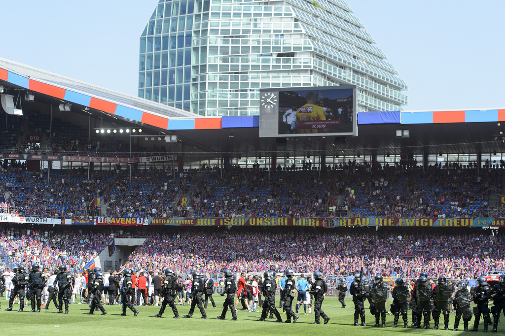 Sion's players celebrate the victory next to security members during the Swiss Cup final soccer match between FC Basel and FC Sion at the St. Jakob-Park stadium in Basel, Switzerland, Sunday, June 7, 2015. (KEYSTONE/Jean-Christophe Bott)