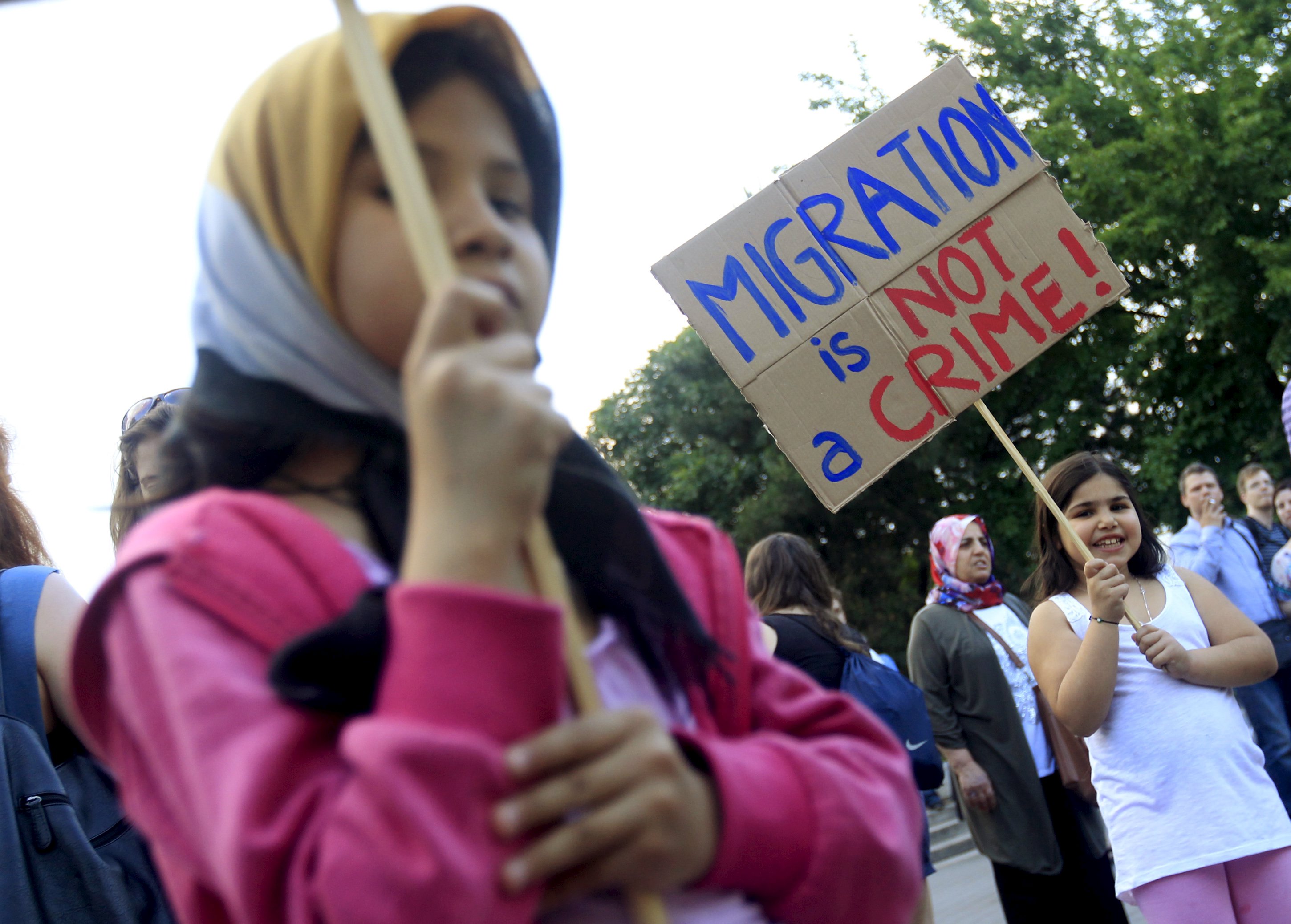 A girl holds a placard during a protest against Hungarian Prime Minister Viktor Orban's immigration policy proposals in central Budapest, Hungary, May 19, 2015. Hungarian Prime Minister Viktor Orban decried EU proposals for migrant quotas as 