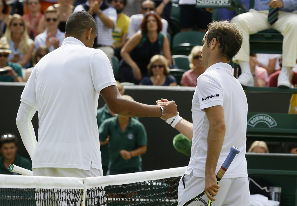 Richard Gasquet of France shakes hands at the net with Nick Kyrgios of Australia, after winning their singles match, at the All England Lawn Tennis Championships in Wimbledon, London, Monday July 6, 2015. Gasquet won 7-5, 6-1, 6-7, 7-6. (AP Photo/Kirsty Wigglesworth)