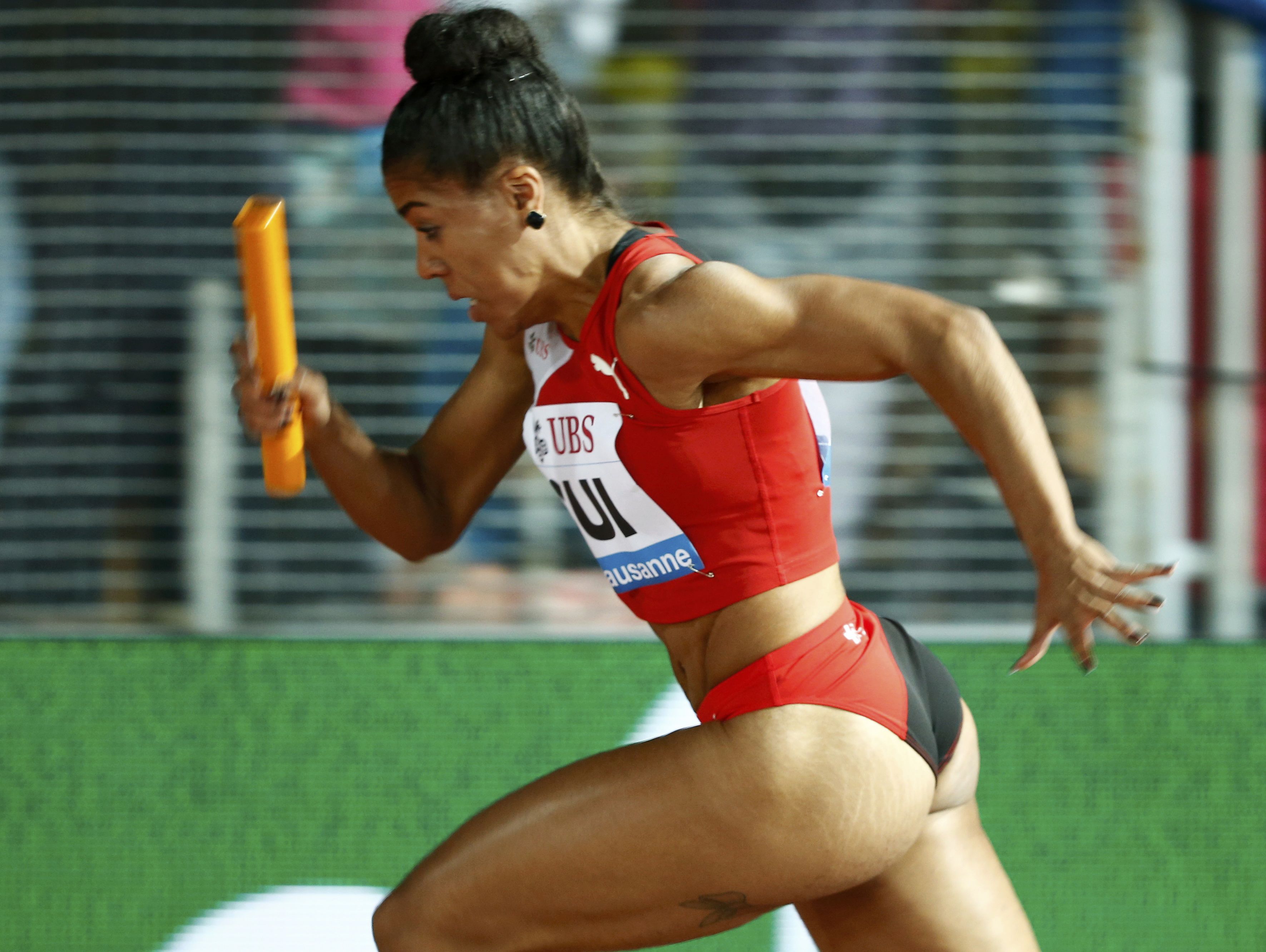 Mujinga Kambundji of Switzerland competes in the 4x100 metres women event at the IAAF Diamond League Athletissima athletics meeting at the Pontaise Stadium in Lausanne, Switzerland, July 9, 2015. REUTERS/Pierre Albouy