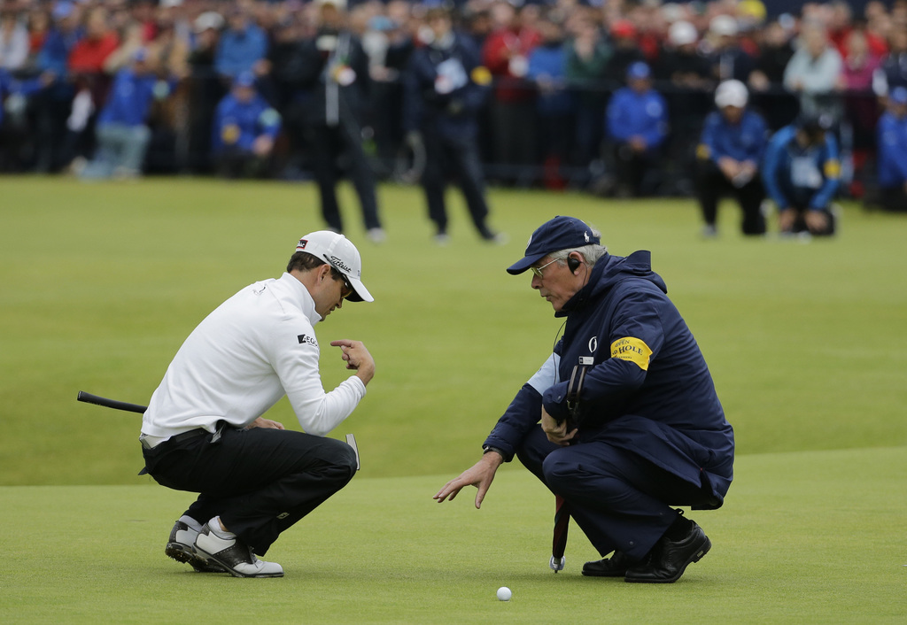 United States� Zach Johnson talks with an official before putting on the 18th during a playoff after the final round at the British Open Golf Championship at the Old Course, St. Andrews, Scotland, Monday, July 20, 2015. (AP Photo/David J. Phillip)