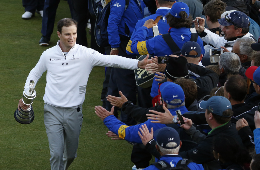 United States� Zach Johnson celebrates with members of the public as he holds the trophy after winning a playoff after the final round at the British Open Golf Championship at the Old Course, St. Andrews, Scotland, Monday, July 20, 2015. (AP Photo/Alastair Grant)